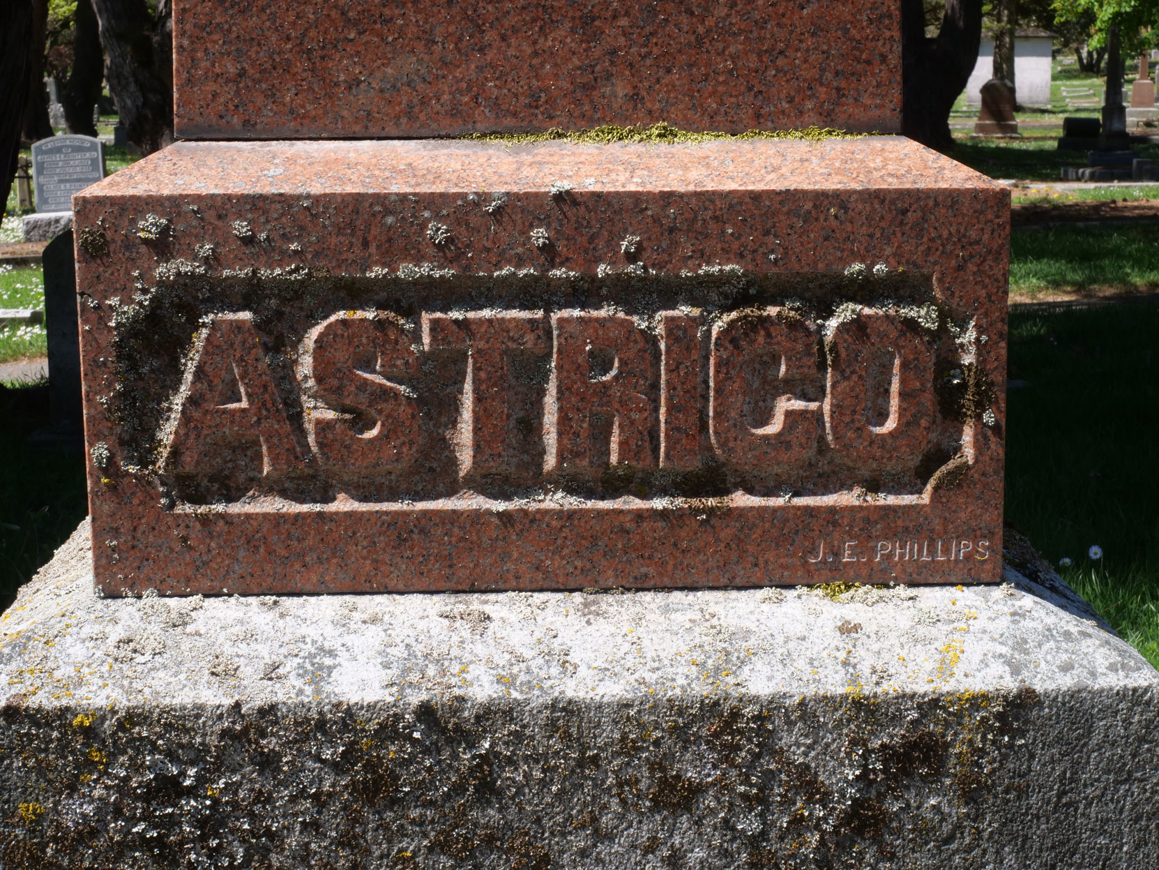 The inscription on the grave of Andrea Astrico in Ross Bay Cemetery. Note the small engraved "J.E. PHILLIPS" in the lower left corner. This could be Joseph Eva Phillips. [photo: Vancouver & Quadra Lodge No. 2 Historian]