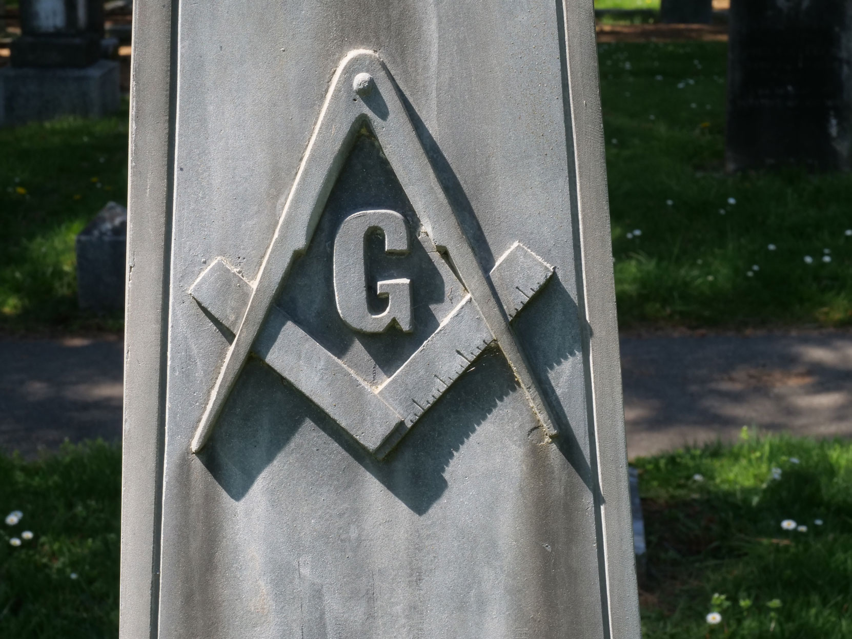 The Masonic Square & Compasses on the grave of Thomas Harding in Ross Bay Cemetery, Victoria, B.C. [photo: Vancouver & Quadra Lodge No. 2 Historian]