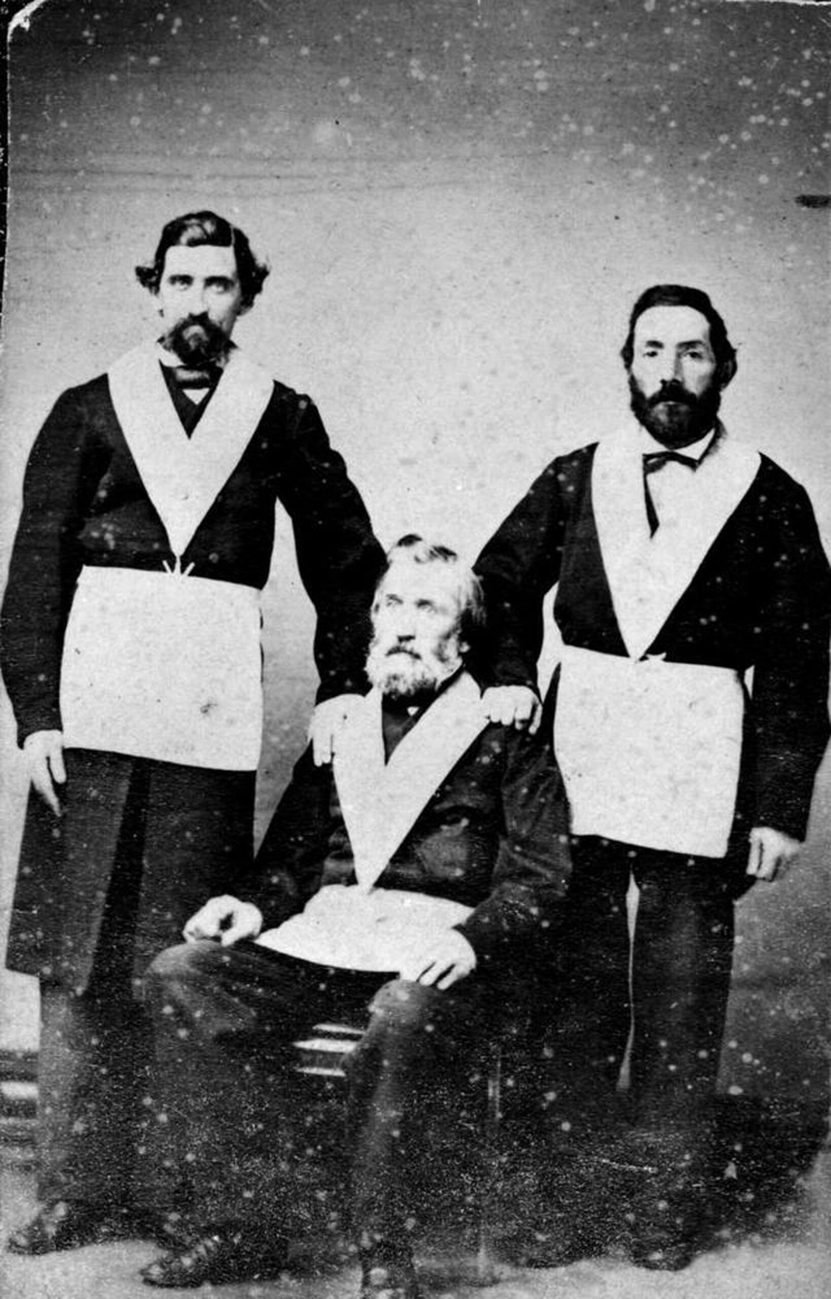 Paul Medana (standing, left) and Innocent Raggazoni (standing, right) with a third unidentified Freemason, circa 1860. [BC Archives photo H-00151]