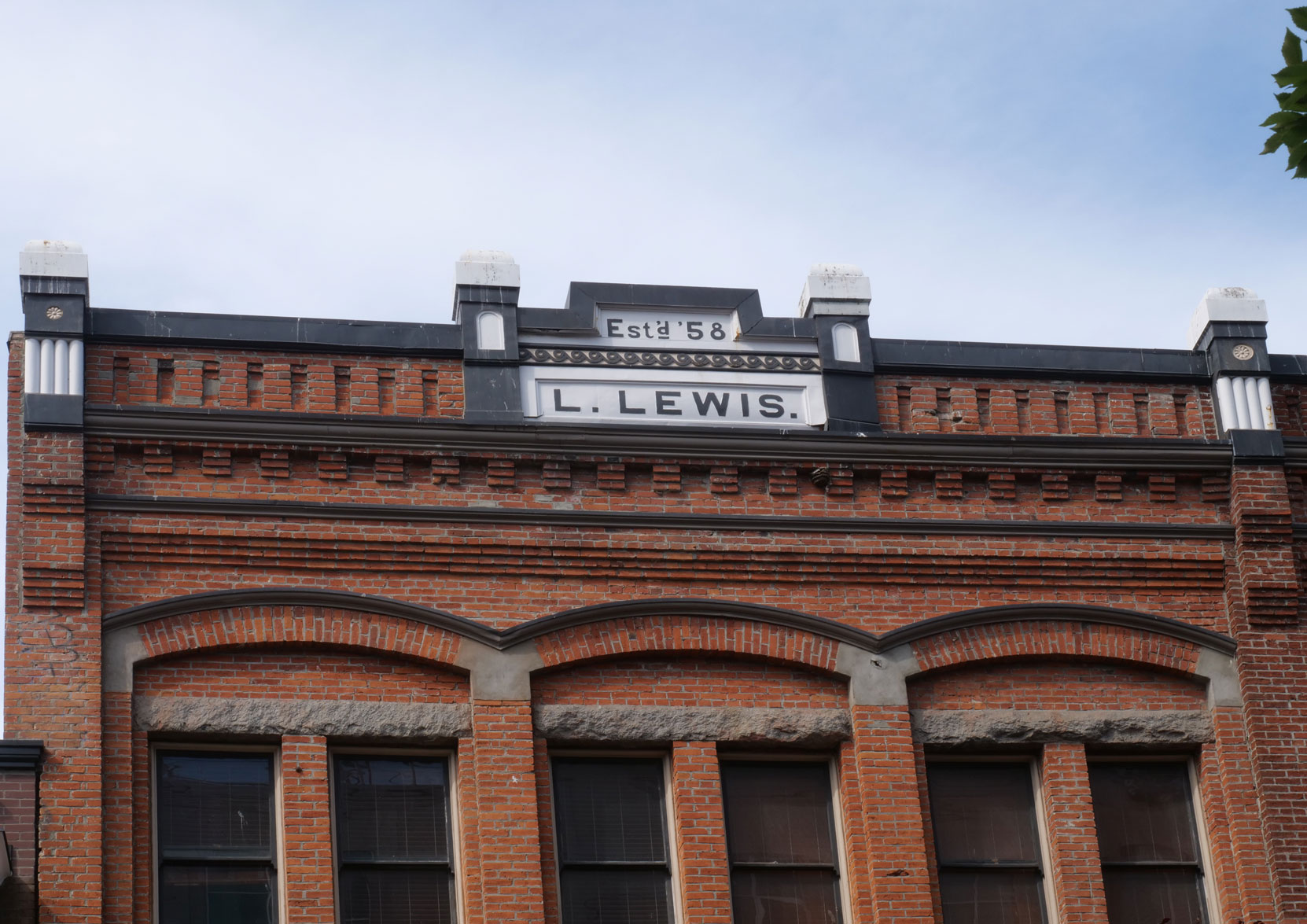 The cornice of the The Lewis and Humphreys Building, 566-570 Yates Street, displays "L. Lewis" This stands for Lewis Lewis, for whom this building was designed and built in 1891 by architect Thomas Hooper. Lewis Lewis was a member of Vancouver & Quadra Lodge No. 2 [photo: Vancouver & Quadra Lodge No. 2 Historian]